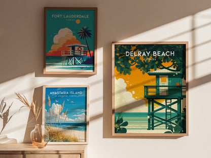 Three framed posters feature vibrant coastal scenes: Fort Lauderdale with a lifeguard stand and palm, Anastasia Island with beach grasses, and Delray Beach with lush greenery and ocean views.