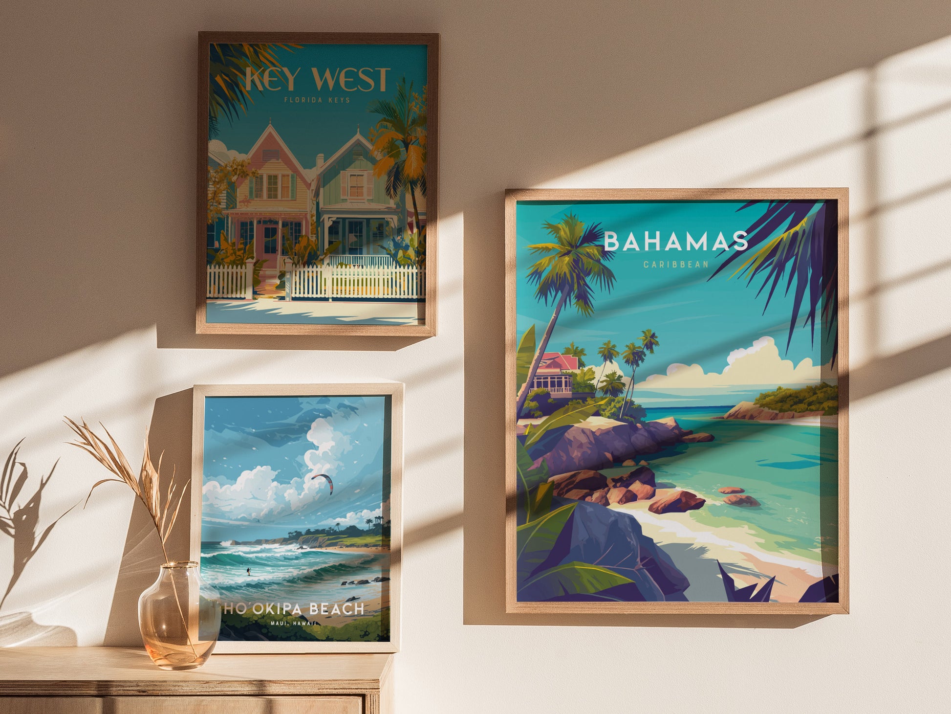 Three framed travel posters hang on a sunlit wall, featuring scenes from Key West, the Bahamas, and Hookipa Beach, each showcasing vibrant coastal landscapes and tropical themes.