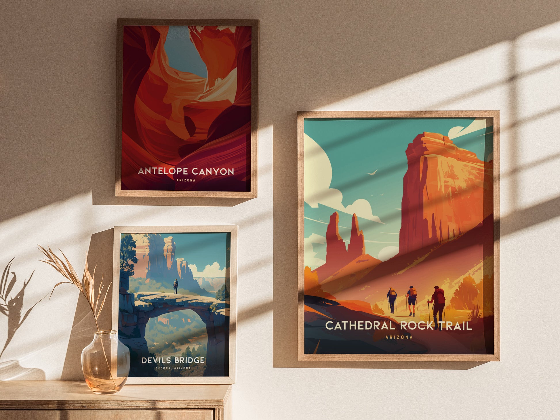 Three framed posters displayed on a wall showcase scenic art: Cathedral Rock Trail, Antelope Canyon, and Devils Bridge, with soft sunlight casting shadows across the prints.