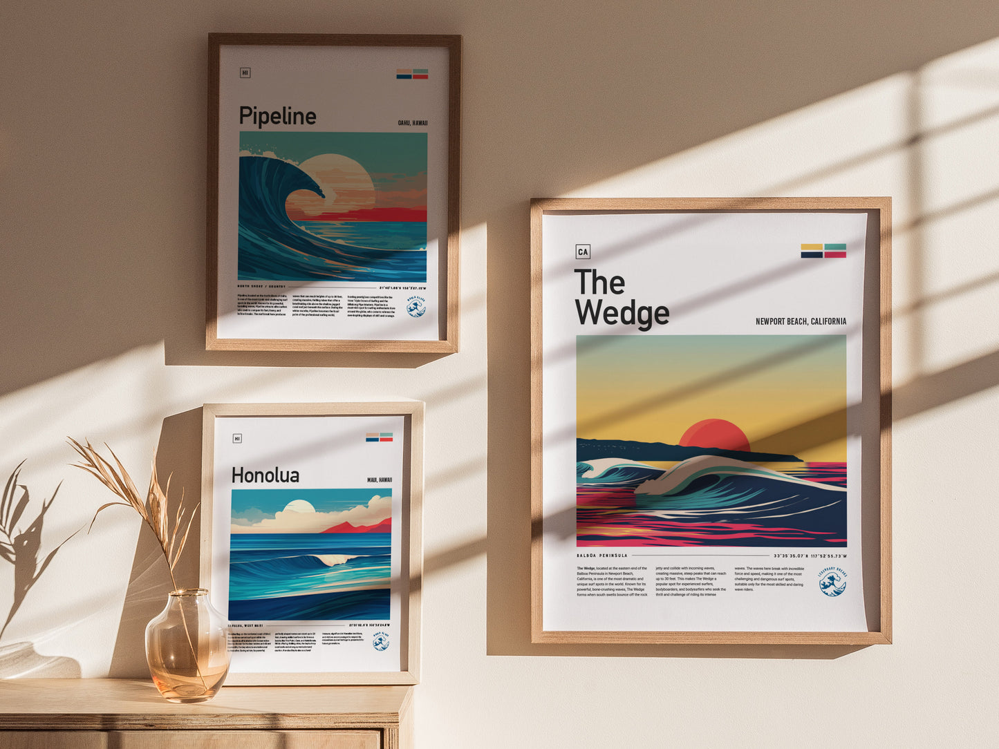 Three framed posters display vibrant surf art, showcasing waves from Pipeline, Honolua, and The Wedge. Sunlight casts shadows on the wall, creating a warm, inviting atmosphere.