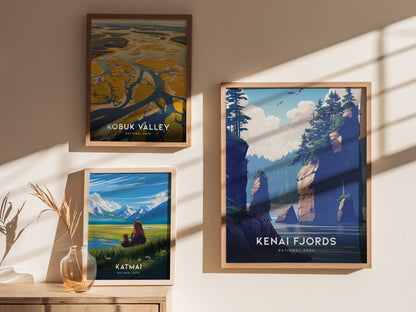 Three framed posters are displayed on a wall, depicting scenic views of Kobuk Valley, Katmai, and Kenai Fjords National Parks, with sunlight casting shadows across them.