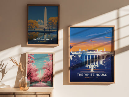 Three framed posters of Washington D.C. landmarks are displayed on a wall, featuring the National Mall, the White House, and the Cherry Blossom Festival, with soft sunlight casting shadows.