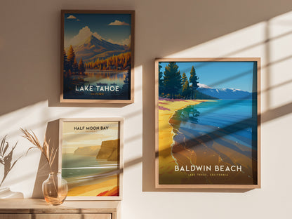 Three framed travel posters are displayed on a sunlit wall. They depict scenic landscapes of Lake Tahoe, Baldwin Beach, and Half Moon Bay, with a small vase nearby.