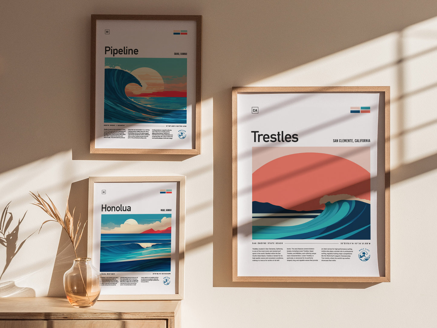 Three framed posters on a wall feature stylized wave art for Pipeline, Honolua, and Trestles surf spots. Soft sunlight casts shadows across the wall, enhancing the minimalist design.