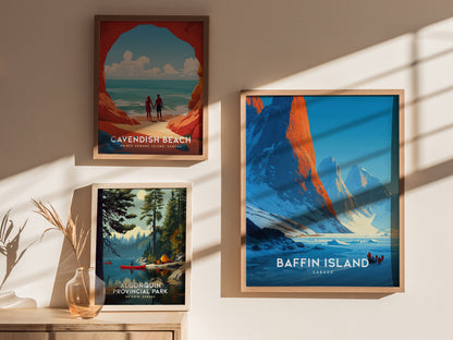 Framed Baffin Island wall art print depicting rugged mountains at sunrise, featuring icy terrain and silhouettes of dog sledders.