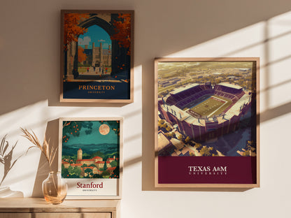 Three framed posters are displayed on a sunlit wall, featuring illustrations of Princeton University, Stanford University, and an aerial view of Texas A&M Universitys stadium.