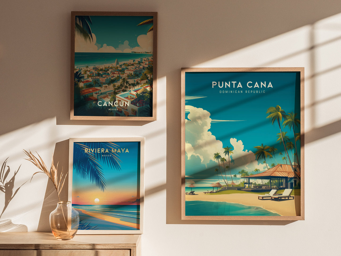 Three framed travel posters are displayed on a sunlit wall. The posters feature vibrant illustrations of Cancun, Riviera Maya, and Punta Cana, with beach scenes, palm trees, and tropical settings.