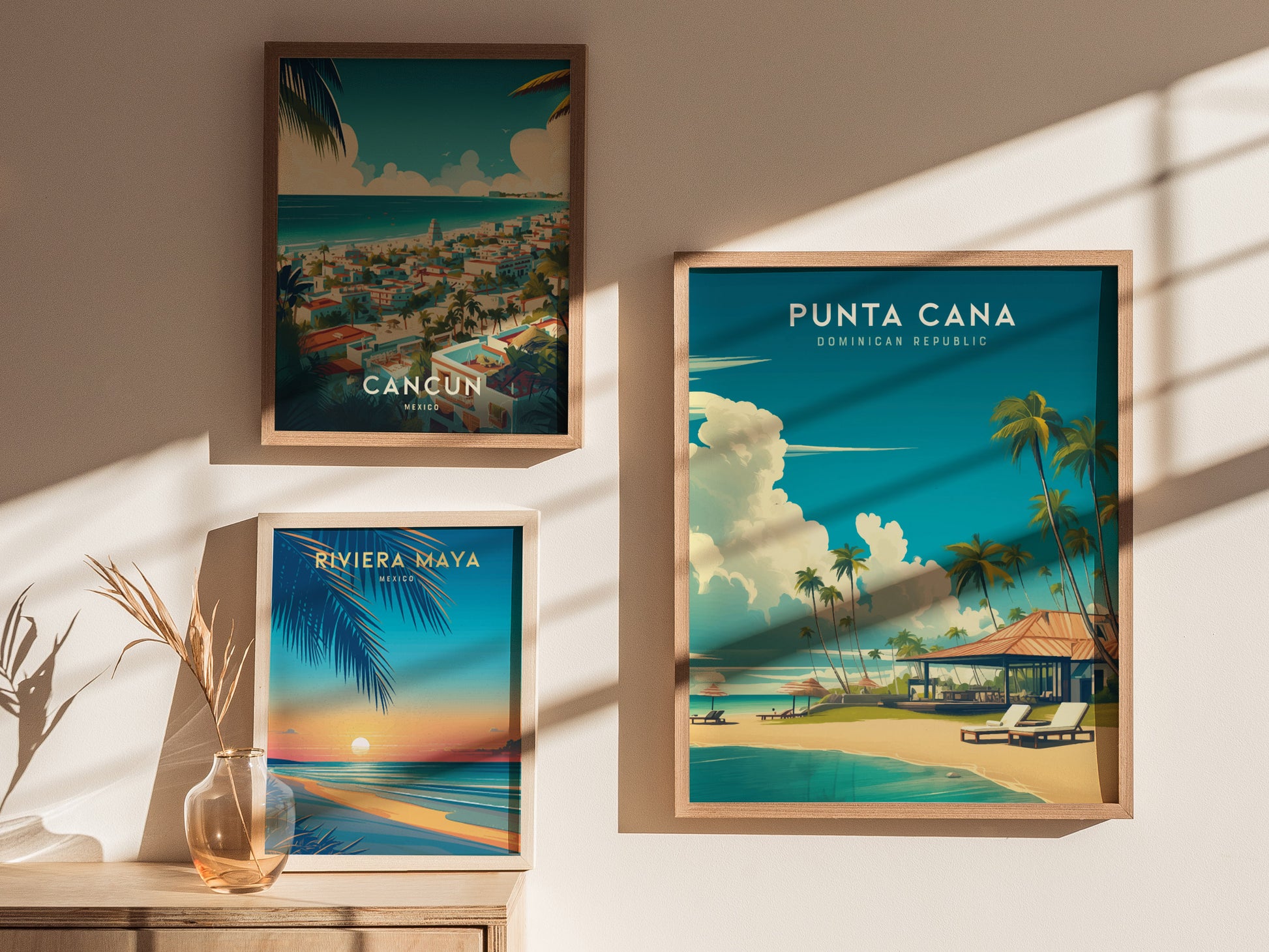 Three framed travel posters are displayed on a sunlit wall. The posters feature vibrant illustrations of Cancun, Riviera Maya, and Punta Cana, with beach scenes, palm trees, and tropical settings.