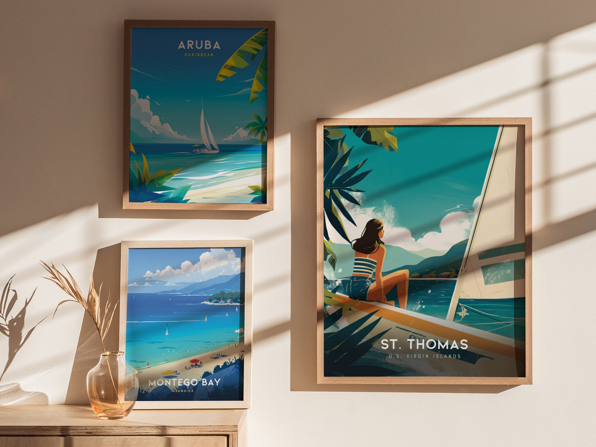 Three framed travel posters are displayed on a beige wall, depicting scenic views of Aruba, Montego Bay, and St. Thomas, each with vibrant colors and tropical themes.