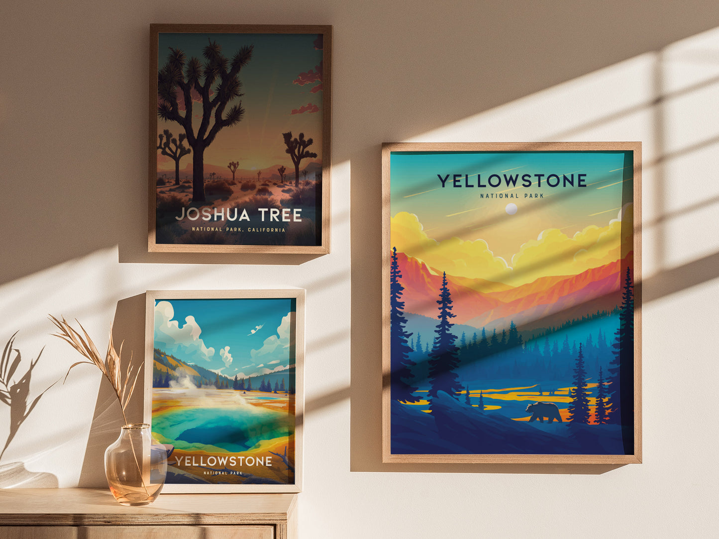 Three framed posters feature vibrant landscapes of Joshua Tree and Yellowstone National Parks. Sunlight casts shadows on the wall, enhancing the colorful nature scenes.