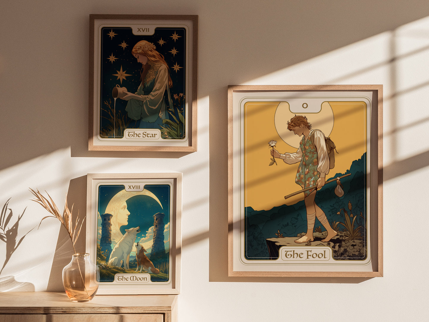 Three tarot posters are displayed on a sunlit wall, featuring The Star, The Moon, and The Fool cards, each depicted with intricate and colorful illustrations.