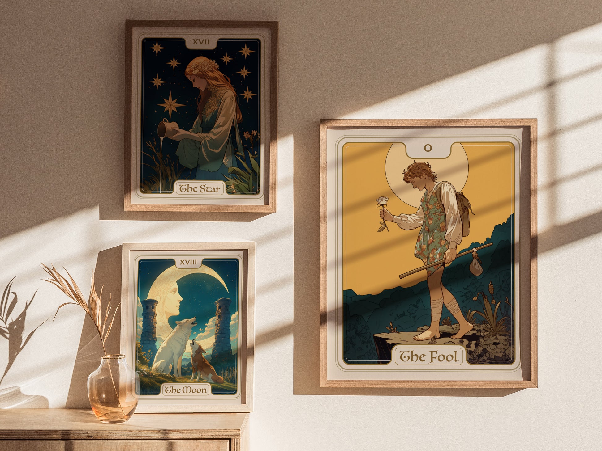 Three tarot posters are displayed on a sunlit wall, featuring The Star, The Moon, and The Fool cards, each depicted with intricate and colorful illustrations.