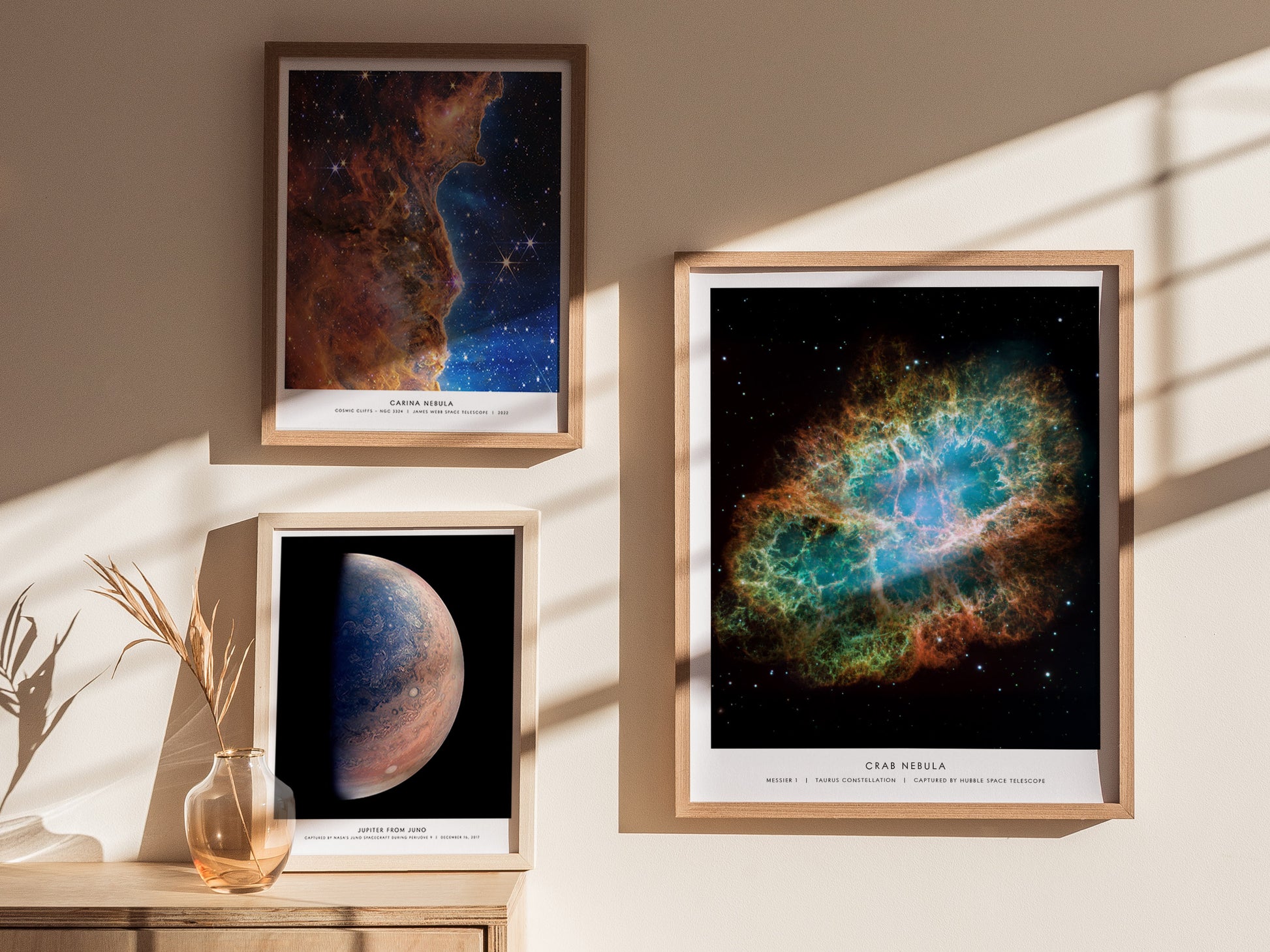 Gallery wall featuring the Crab Nebula poster paired with other NASA space prints in matching wood frames.