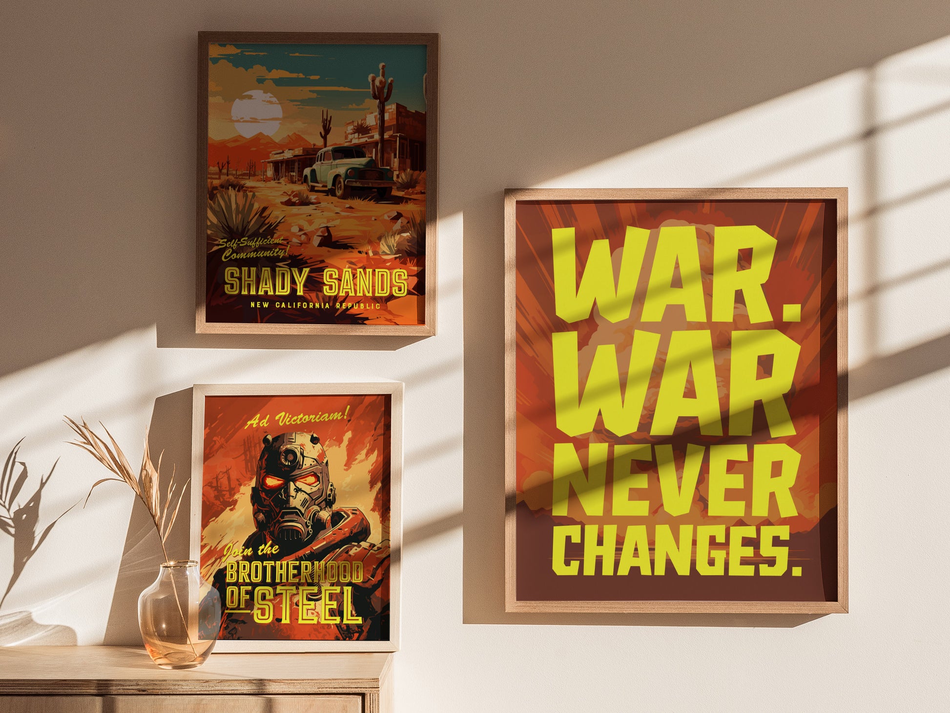 Three framed posters are displayed on a wall, featuring bold yellow text saying WAR. WAR NEVER CHANGES. and scenes from a desert and futuristic warrior.