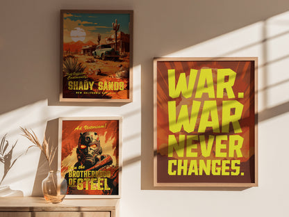 Three framed posters are displayed on a wall, featuring bold yellow text saying WAR. WAR NEVER CHANGES. and scenes from a desert and futuristic warrior.