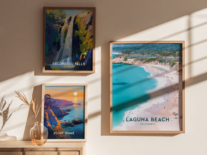 Three framed posters displayed on a wall showcase vibrant landscapes: Escondido Falls, Point Dume, and Laguna Beach. Sunlight casts soft shadows across the images, enhancing their vivid colors.