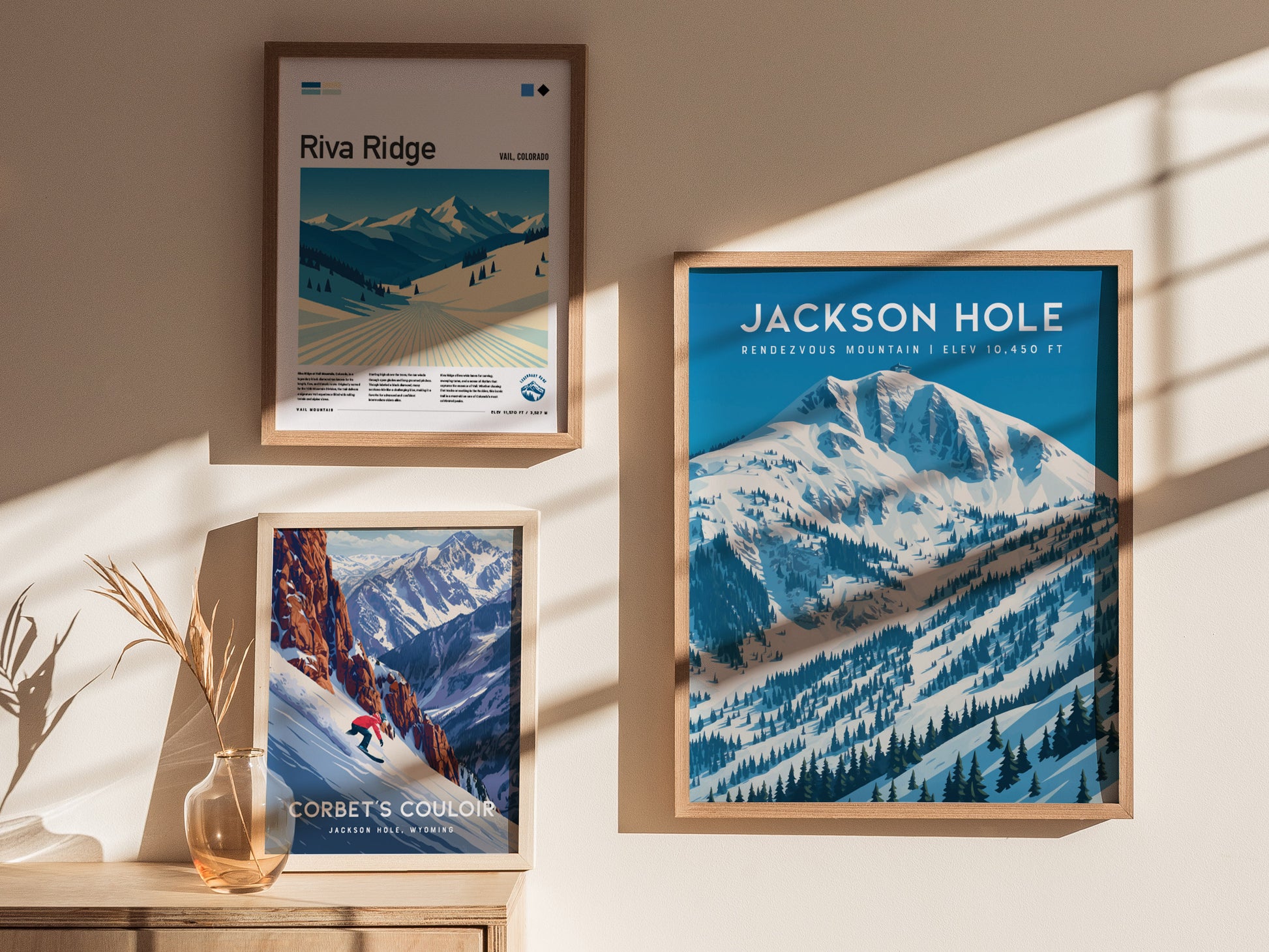 Framed Rendezvous Mountain wall art features a snow-covered peak in Jackson Hole, showcasing cool blues and bold graphic lines.