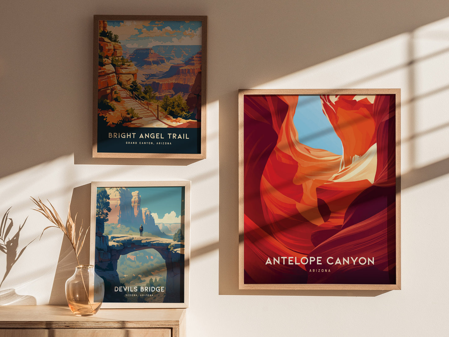 Three framed posters are displayed on a sunlit wall. They depict Bright Angel Trail, Antelope Canyon, and Devils Bridge, showcasing vibrant landscapes and natural beauty.