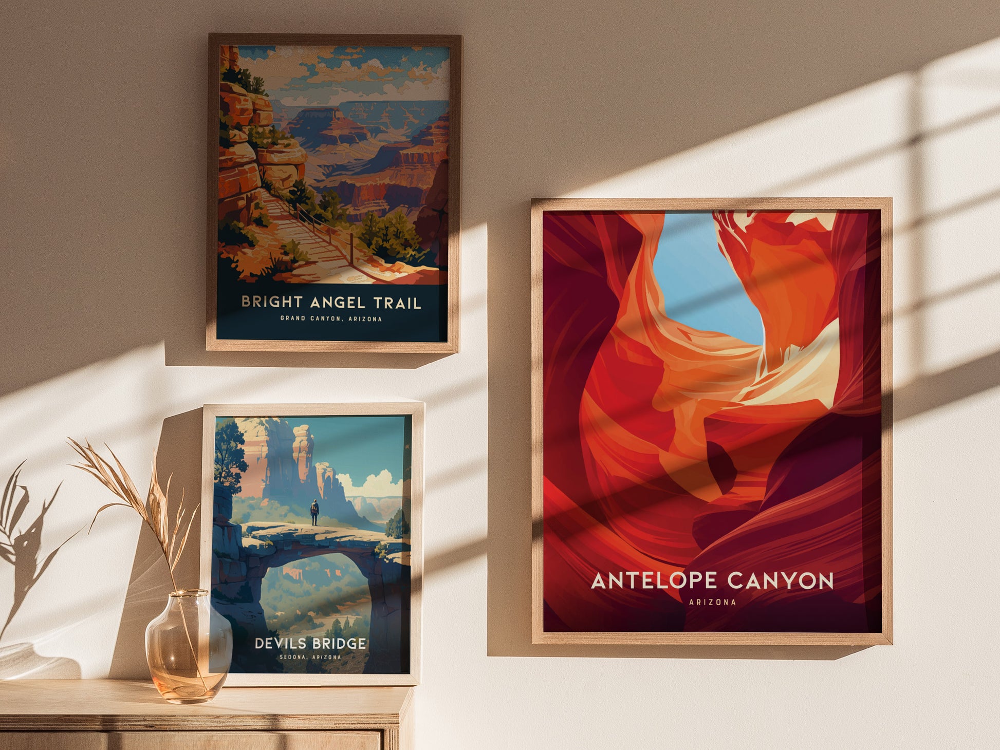 Three framed posters are displayed on a sunlit wall. They depict Bright Angel Trail, Antelope Canyon, and Devils Bridge, showcasing vibrant landscapes and natural beauty.