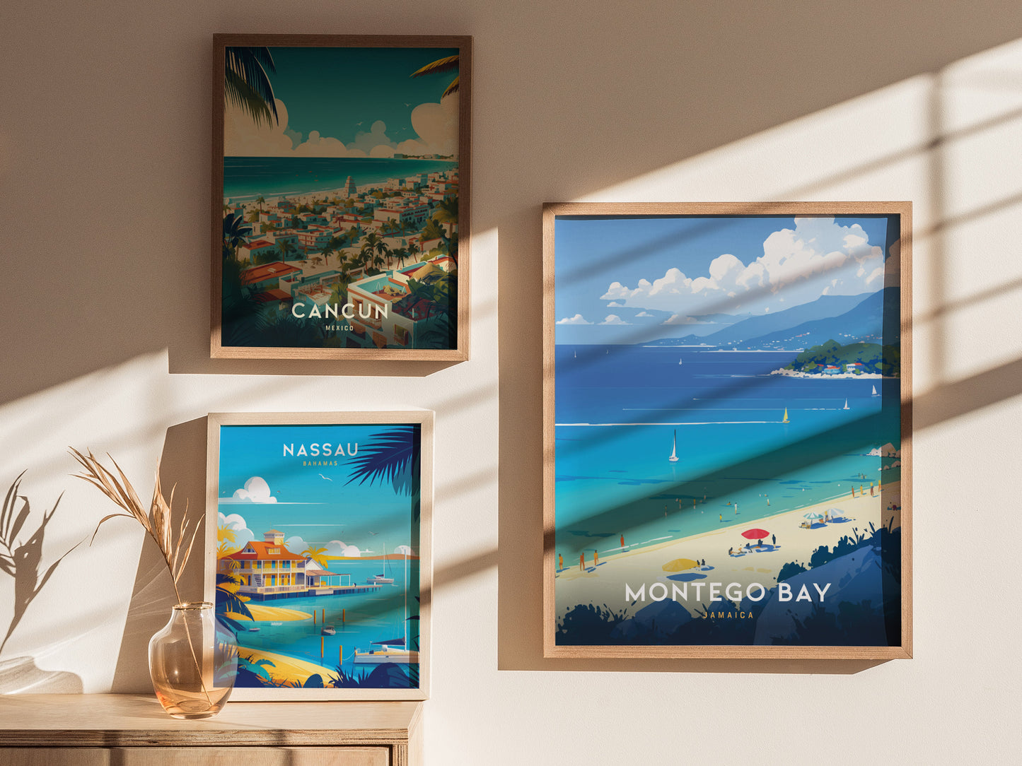 Framed travel posters of Cancun, Nassau, and Montego Bay are displayed on a sunlit wall. A vase with dried plants sits on a wooden table beneath the Nassau poster.