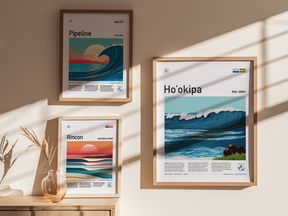 Three framed posters featuring stylized wave illustrations are displayed on a sunlit wall. A small vase with dried grass is placed on a wooden surface below.