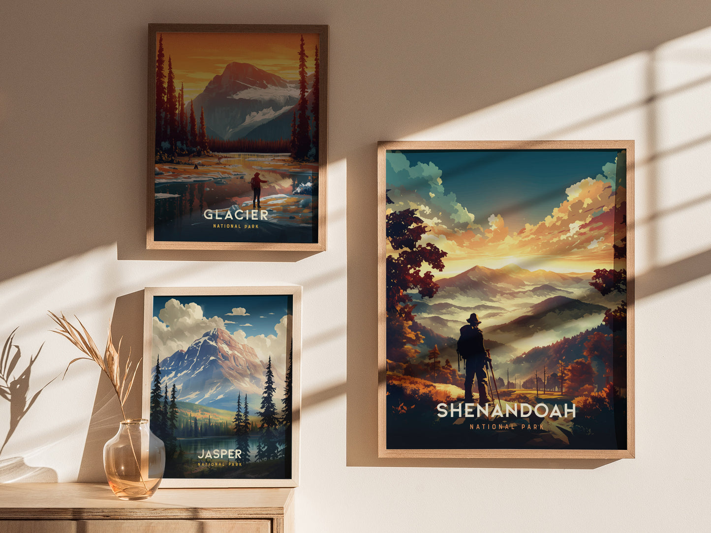 Three framed national park posters are displayed on a wall, featuring Glacier, Jasper, and Shenandoah parks with striking landscapes and vibrant colors.
