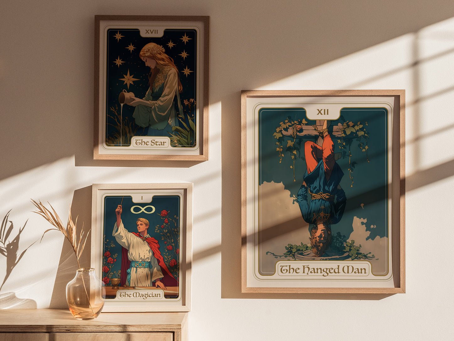 Three framed tarot card posters are displayed on a wall: The Star, The Magician, and The Hanged Man, with sunlight casting gentle shadows.