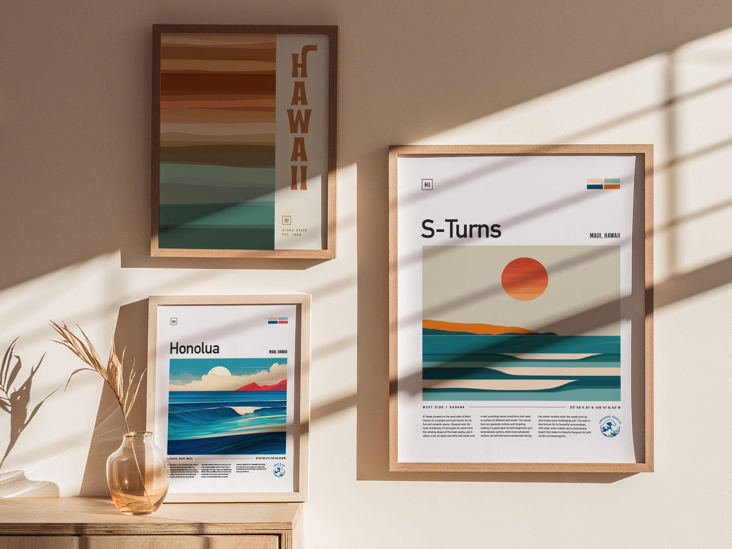 Three framed posters on a sunlit wall display minimalist beach and surf art, featuring locations in Hawaii, including S-Turns and Honolua, with warm.