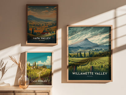 Three framed posters display scenic vineyard landscapes of Napa Valley, Willamette Valley, and Paso Robles, set against a softly lit wall with shadows and a decorative vase.