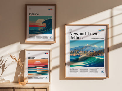 Three framed posters hang on a wall, featuring stylized beach scenes labeled Pipeline, Rincon, and Newport Lower Jetties. Sunlight casts shadows, enhancing the warm, coastal ambiance.