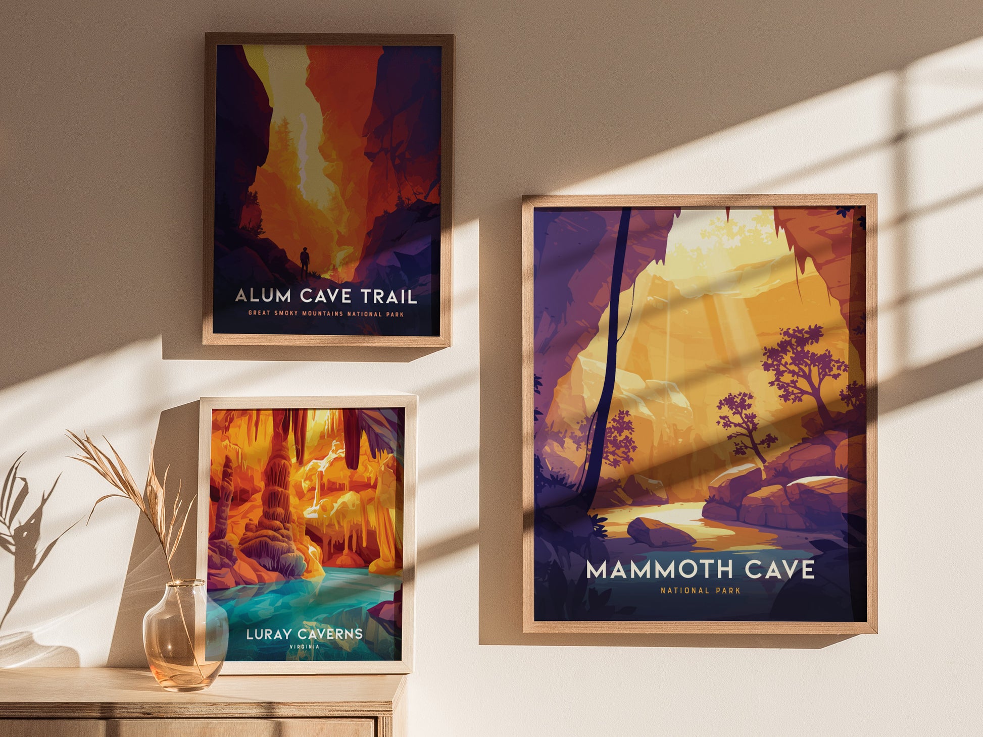 Three framed posters are displayed on a wall: Alum Cave Trail, Luray Caverns, and Mammoth Cave National Park, each featuring vibrant cave and natural landscape illustrations.