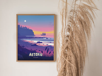 Framed poster of Astoria, Oregon, featuring a colorful sunset over the ocean with a pirate ship in the distance, displayed next to tall pampas grass.
