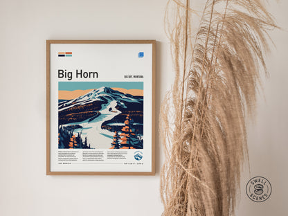Framed poster of Big Horn ski run in Big Sky, Montana, featuring a stylized mountain landscape with a snow-covered trail. Decorative dried grasses are visible beside the poster.