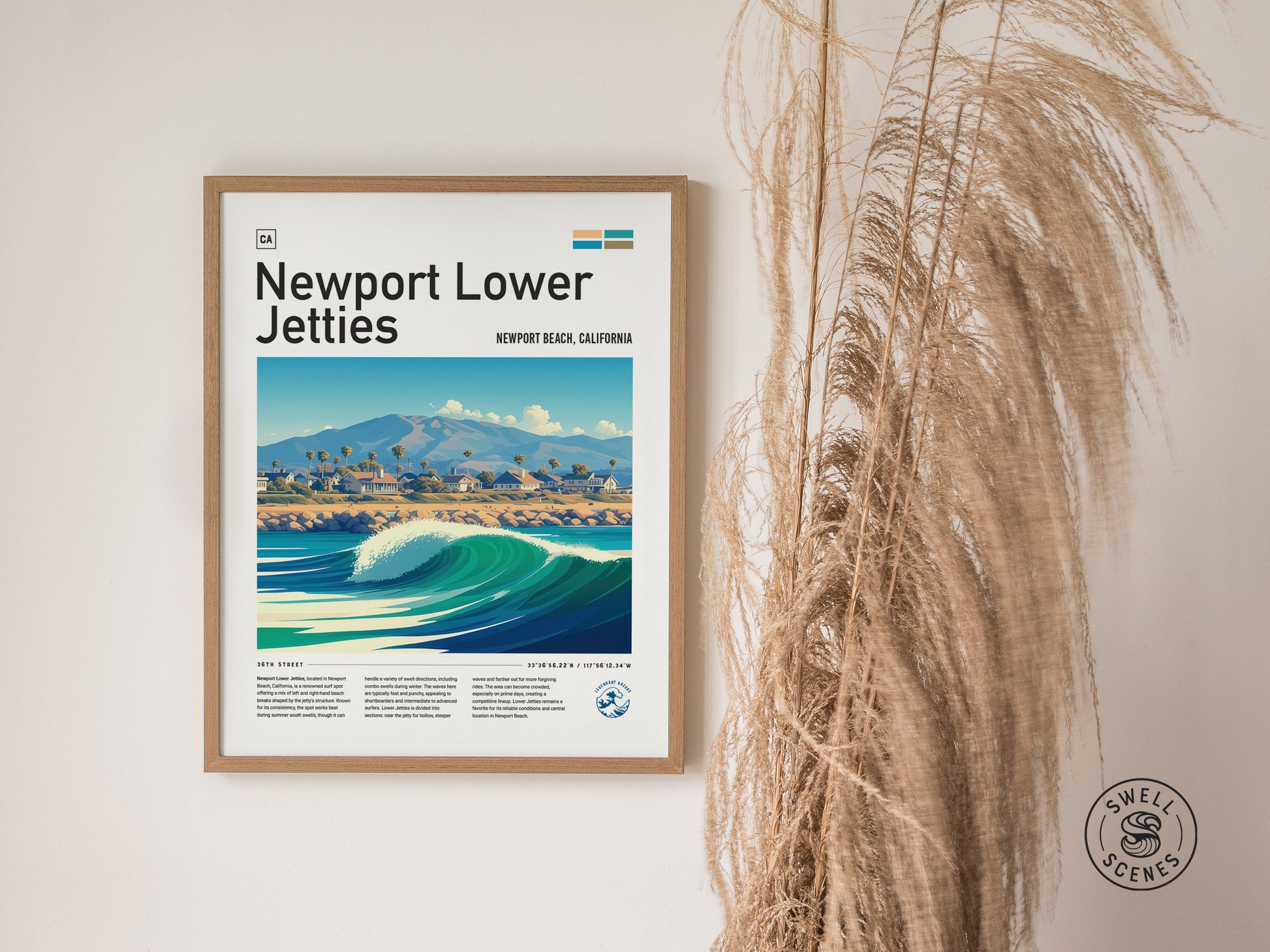 Framed Newport Lower Jetties poster on a white wall, depicting a vibrant ocean wave and coastal landscape, with decorative dried grasses to the side. Swell Scenes logo in the corner.