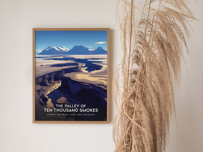 A framed poster of The Valley of Ten Thousand Smokes featuring rugged volcanic landscapes in Katmai National Park hangs on a wall beside decorative dried grasses.