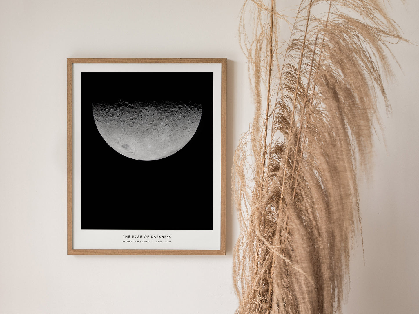 Framed lunar print featuring detailed craters of the half-moon phase against black, titled "Edge of Darkness," from Artemis II mission.
