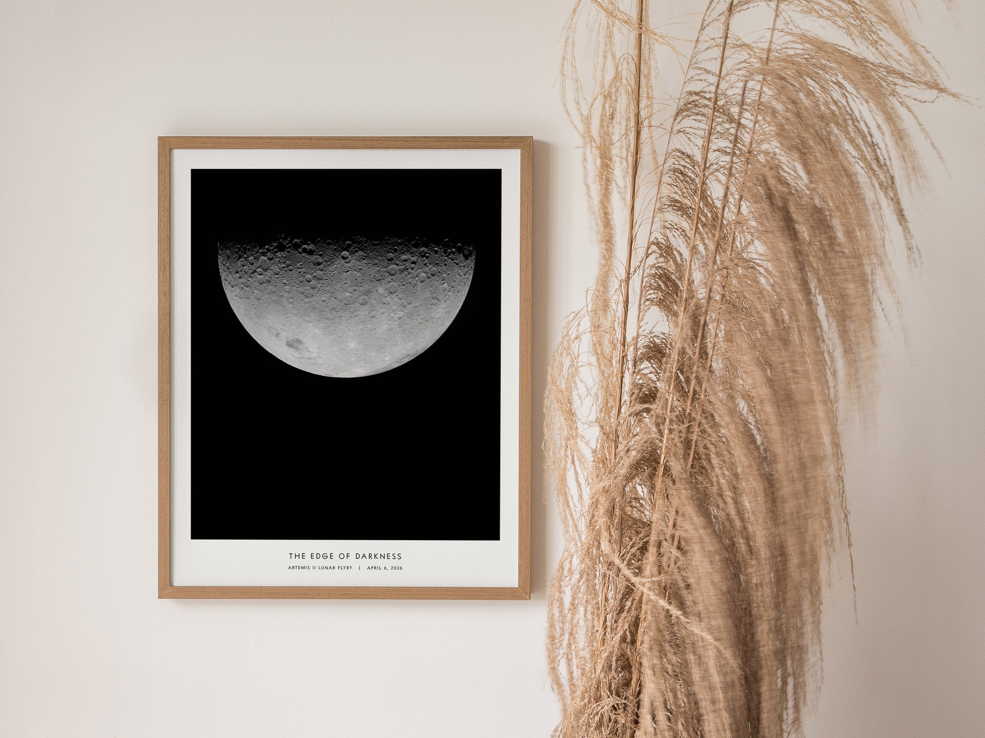 Framed lunar print featuring detailed craters of the half-moon phase against black, titled "Edge of Darkness," from Artemis II mission.