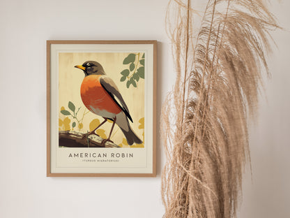 A framed American Robin art print features a red-breasted bird on a branch, set against a beige background. Its displayed next to tall, dried pampas grass.