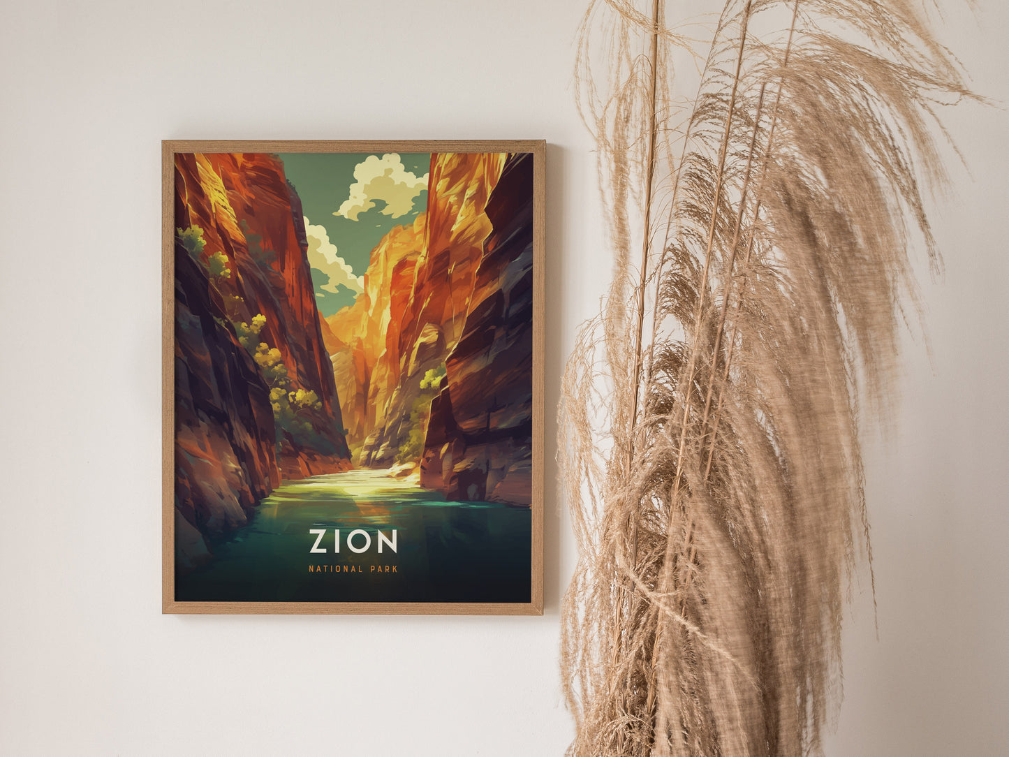 A framed poster of Zion National Parks The Narrows features vivid red rock cliffs and a serene river, set against a decorative dried plant on a light wall.