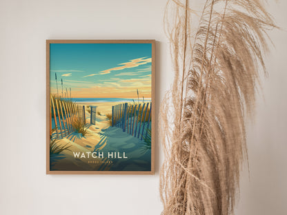 A framed poster of Watch Hill, Rhode Island, features a serene beach scene with sand dunes, wooden fences, and a colorful sunset over the ocean. Pampas grass decorates the background.