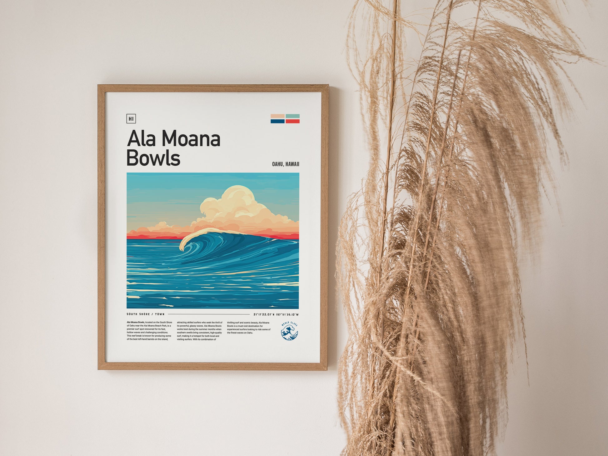 Framed poster of Ala Moana Bowls with a stylized wave illustration, set against a light wall decorated with tall, dried grasses.
