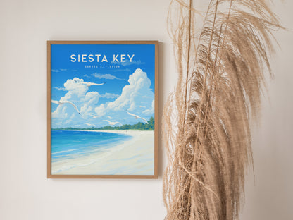 Framed Siesta Key poster depicting a serene beach with turquoise waters and blue sky, placed next to tall, dried pampas grass.