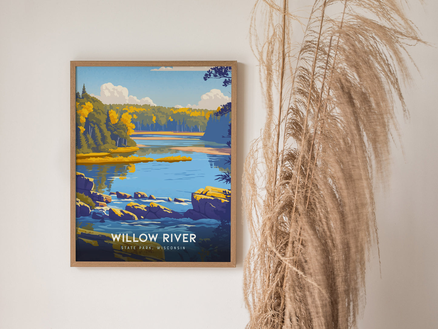 A framed art print depicting a serene landscape of Willow River State Park in Wisconsin, showcasing vibrant blue waters, lush green trees, and rocky shores under a bright sky.