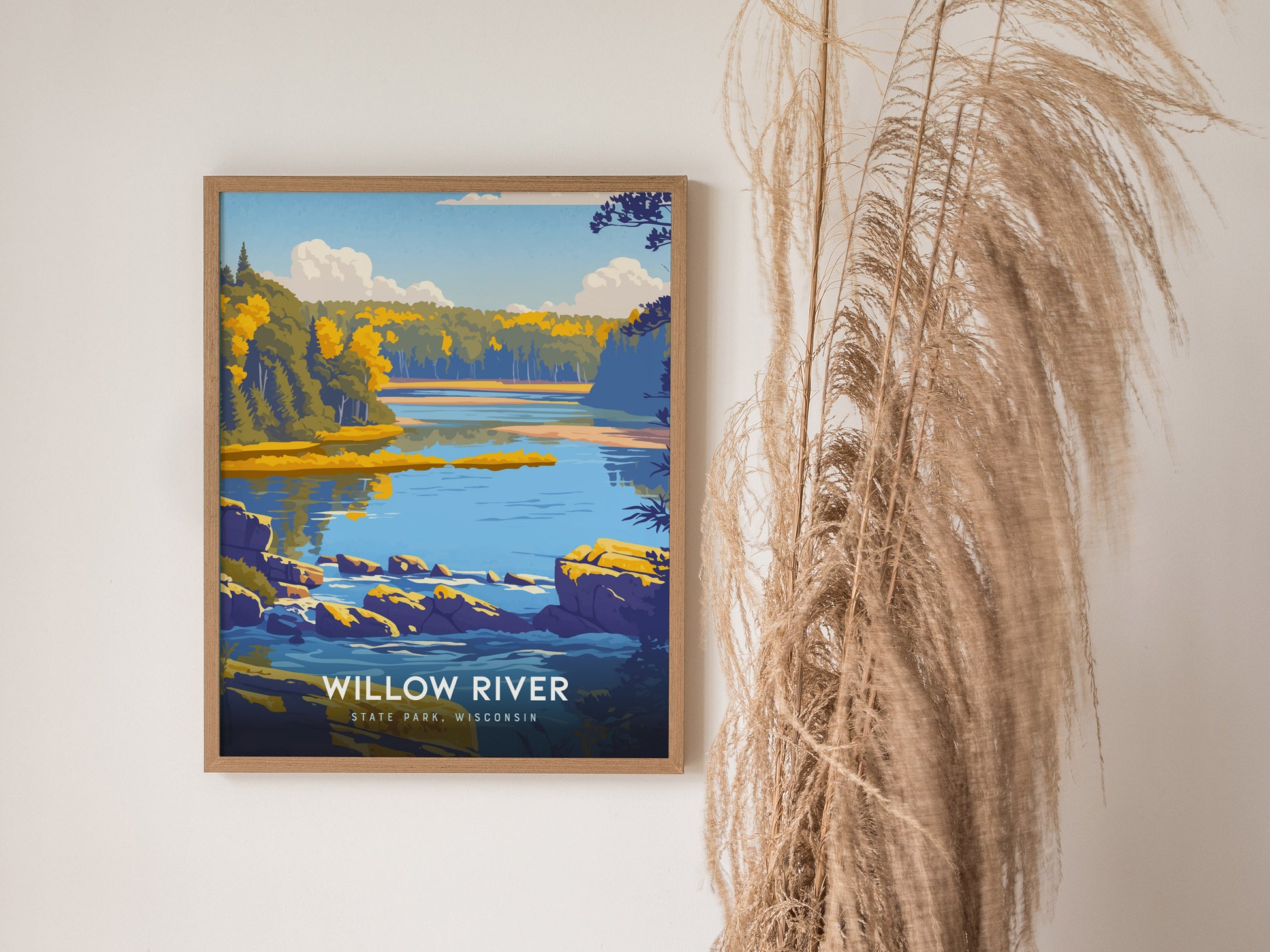 A framed art print depicting a serene landscape of Willow River State Park in Wisconsin, showcasing vibrant blue waters, lush green trees, and rocky shores under a bright sky.