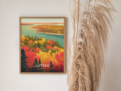 A framed poster of Lutsen, Minnesota, displays vibrant autumn foliage with red, yellow, and green trees overlooking a blue lake. Pampas grass decorates the right side.