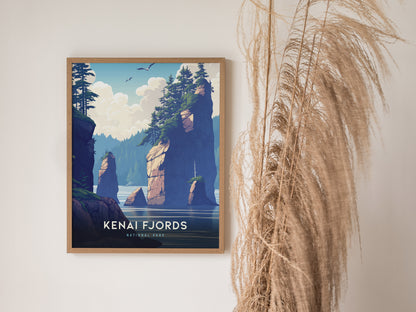 A framed poster of Kenai Fjords National Park features illustrated cliffs and trees, with seagulls flying above. Its displayed on a wall alongside tall, dried grass.