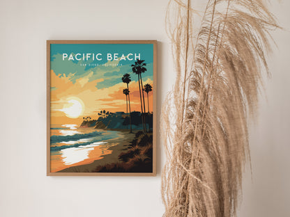 A framed poster of Pacific Beach, San Diego, with a sunset over the ocean, silhouetted palm trees, and vibrant colors. Its displayed on a wall next to tall, dried grasses, adding a coastal vibe.