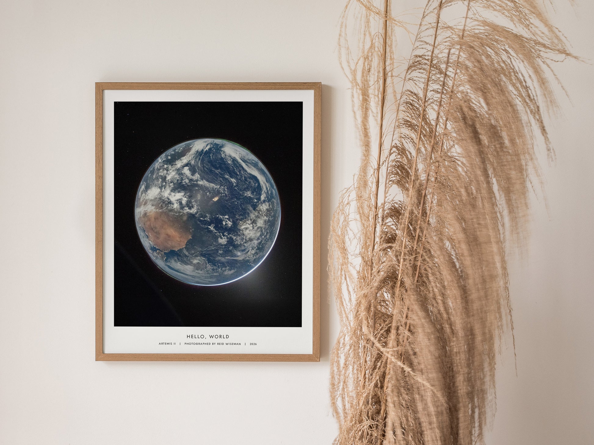 Framed poster showcasing a stunning view of Earth from space, highlighting vibrant blues, browns, and whites in a realistic NASA print.