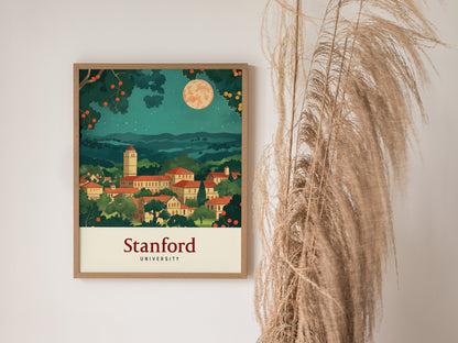A framed Stanford University poster featuring a vintage-style illustration of the campus under a starry sky, with trees and a large moon, hangs beside tall, dried grasses.