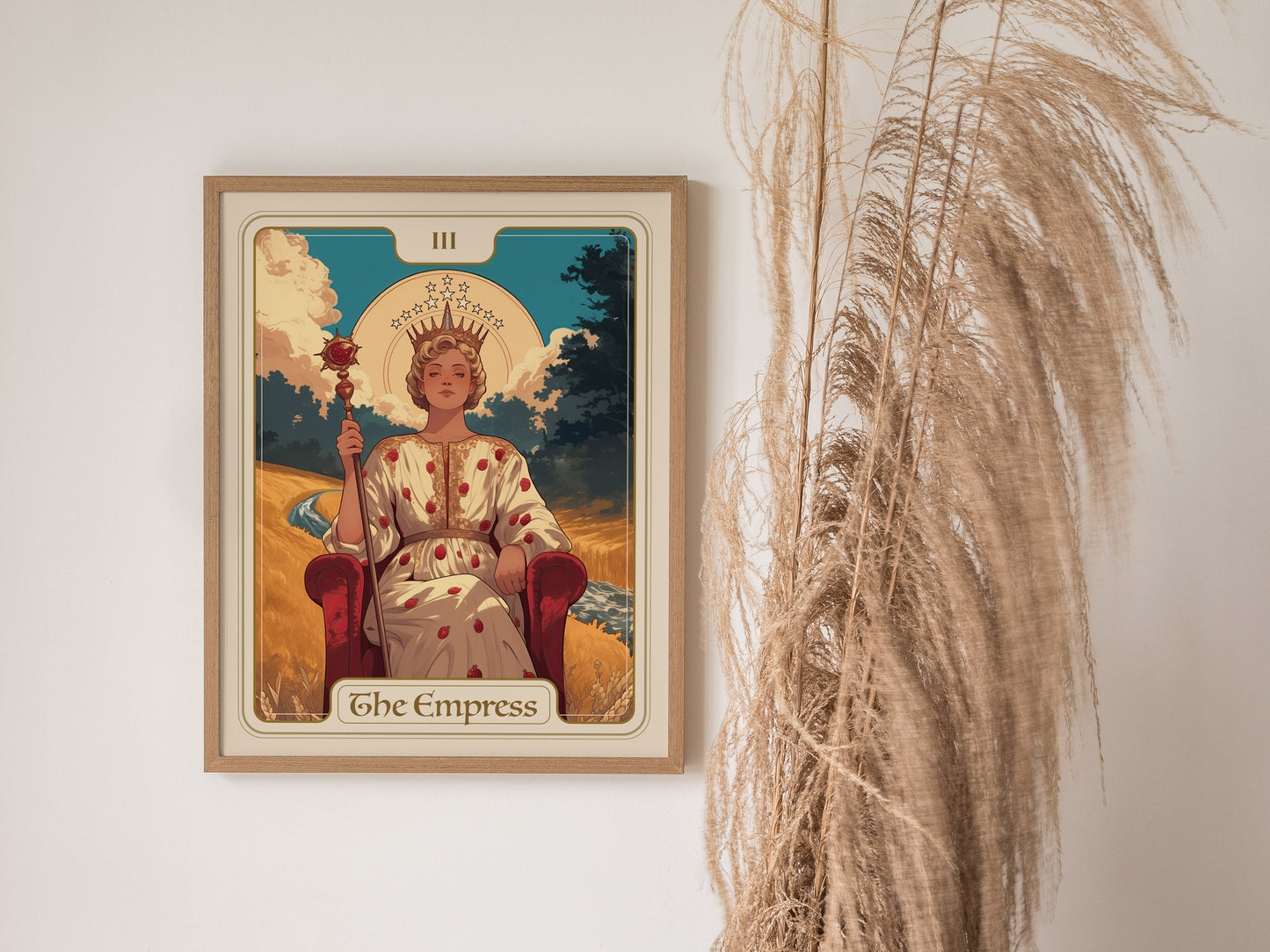 The image shows an Empress Tarot card poster framed on a wall, depicting a crowned woman seated on a throne with a scepter, accompanied by pampas grass.